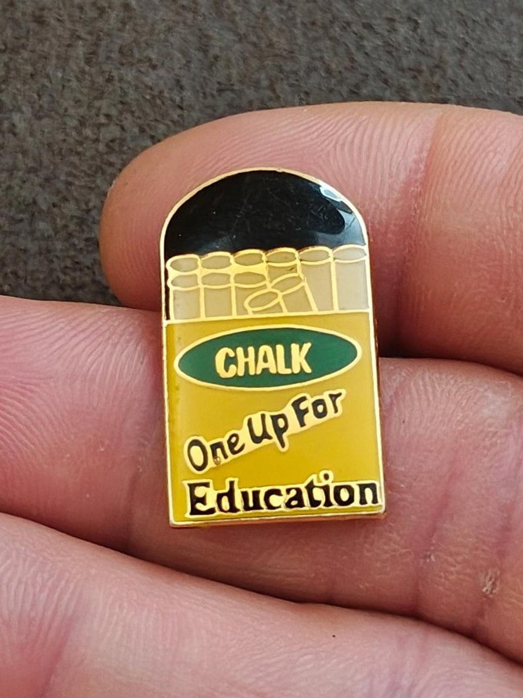Gold-tone enamel teacher pin close-up, green “CHALK” banner and “One Up For Education”