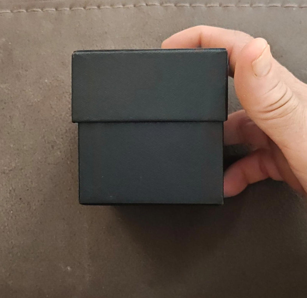 Dark gray watch gift box held in hand