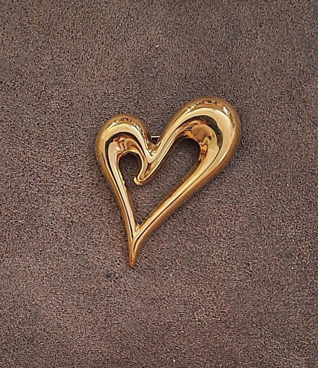Gold heart pin with open center, shiny raised edges and heart cutout