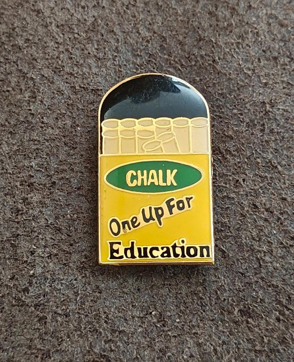 Gold-tone enamel teacher pin front, green “CHALK” band and “One Up For Education” text
