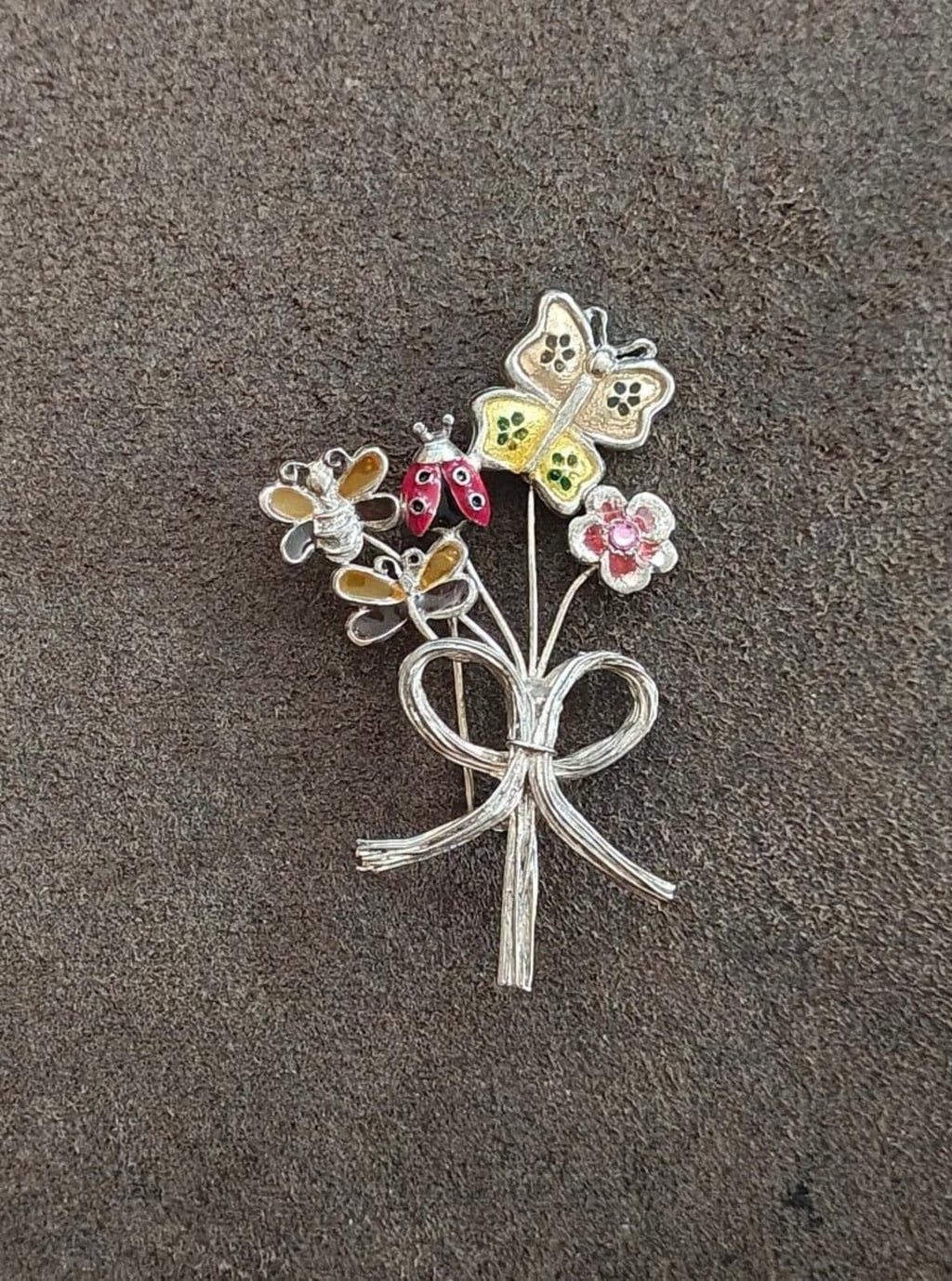 Silver-tone bouquet brooch with colorful flowers and a curled-heart bow design