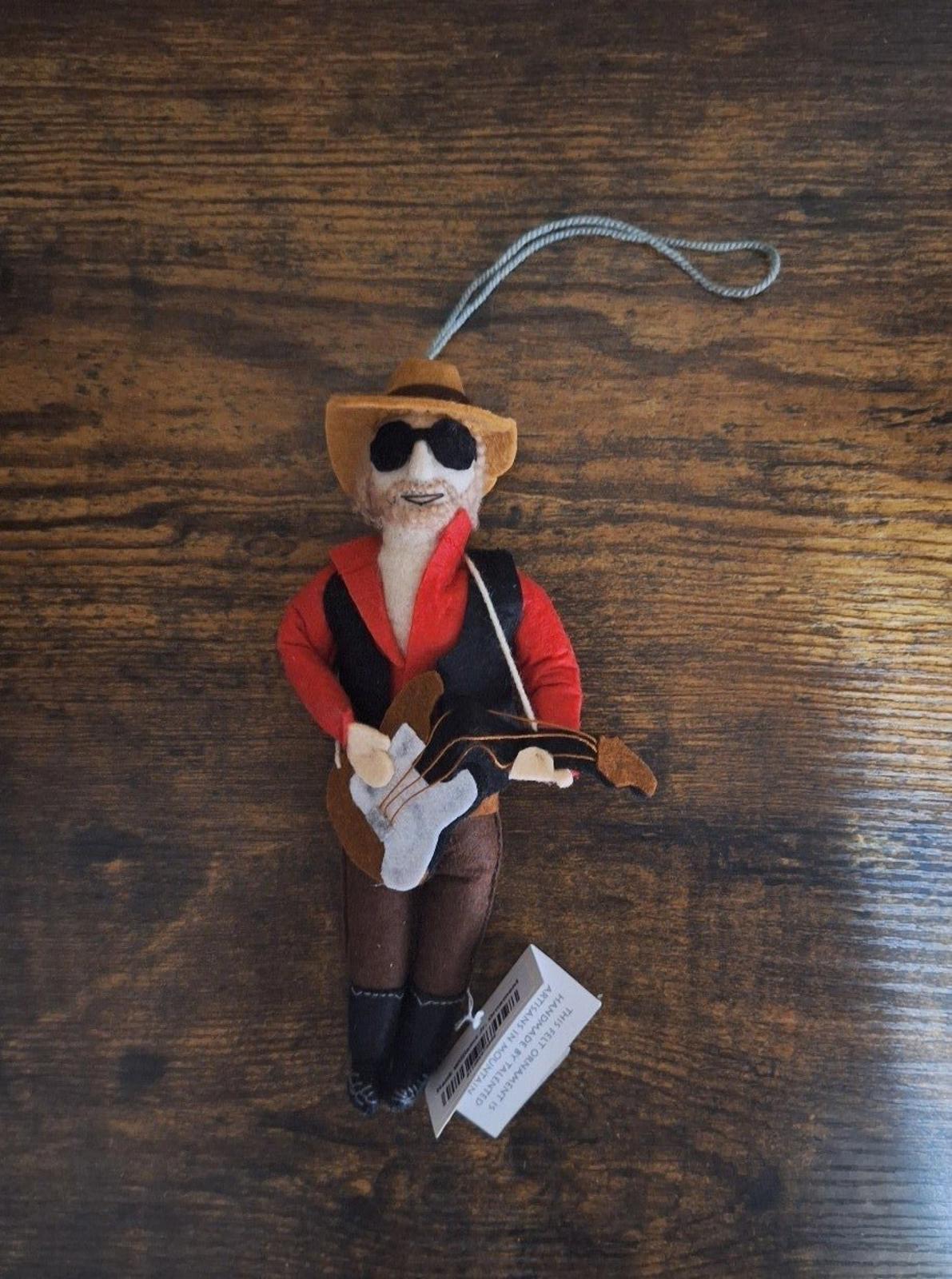 Felt and wool musician ornament standing with red jacket, sunglasses, guitar, and loop