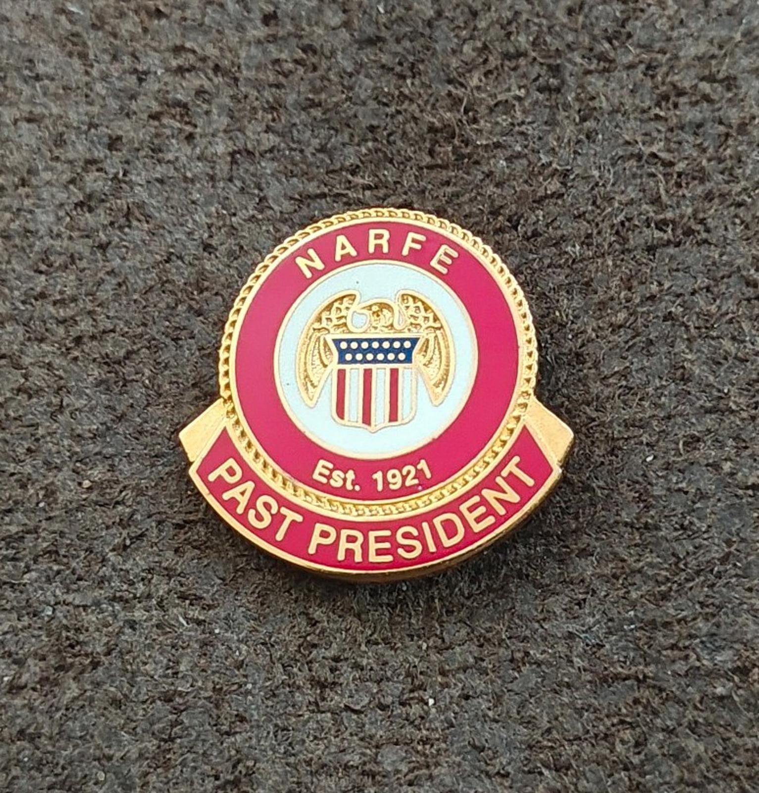 Red and gold enamel commemorative pin with “NARFE” ring and “PAST PRESIDENT”