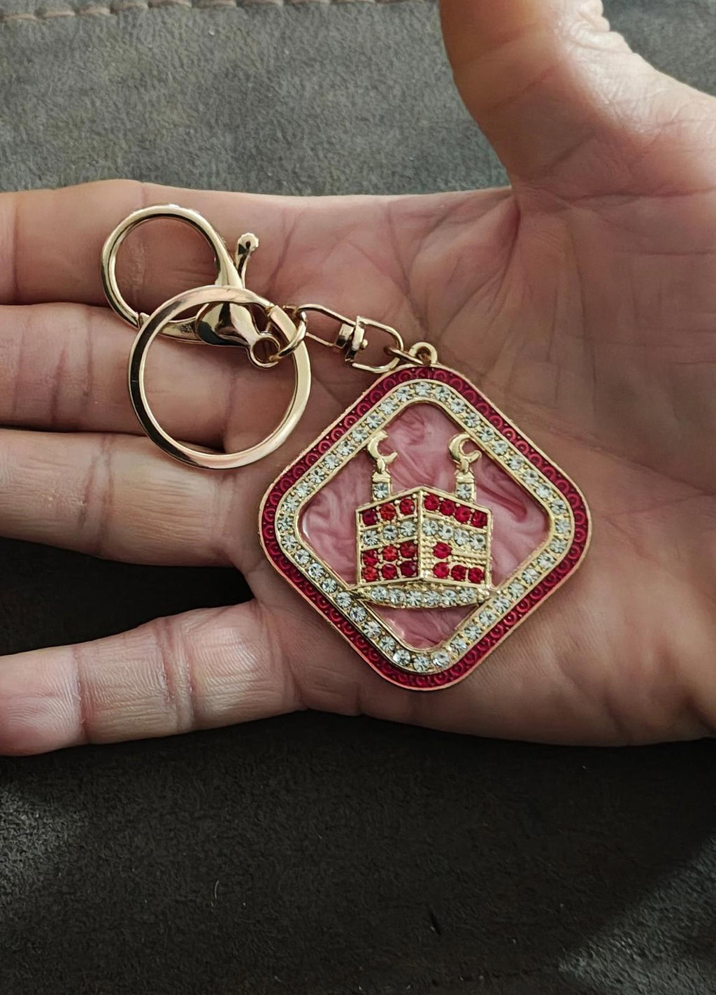 Pink crown keychain charm in a red diamond frame with sparkling rhinestone edge trim
