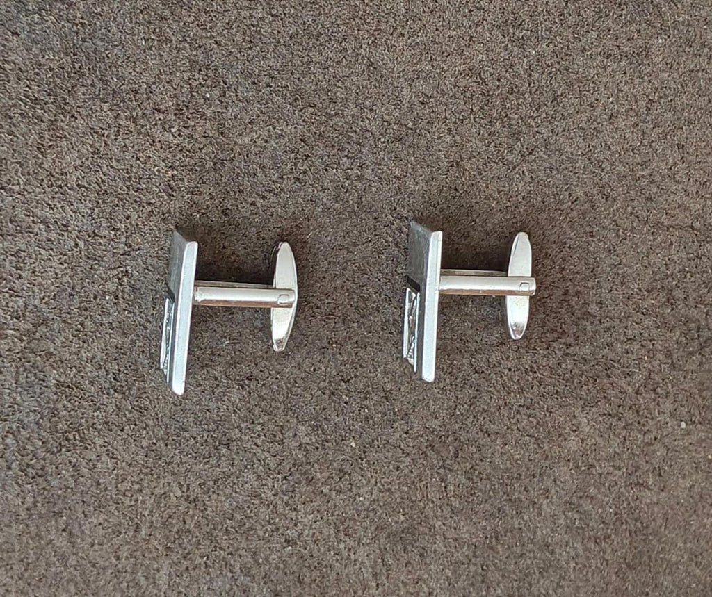 Silver-tone cufflink backs shown with cylindrical posts and round backing ends