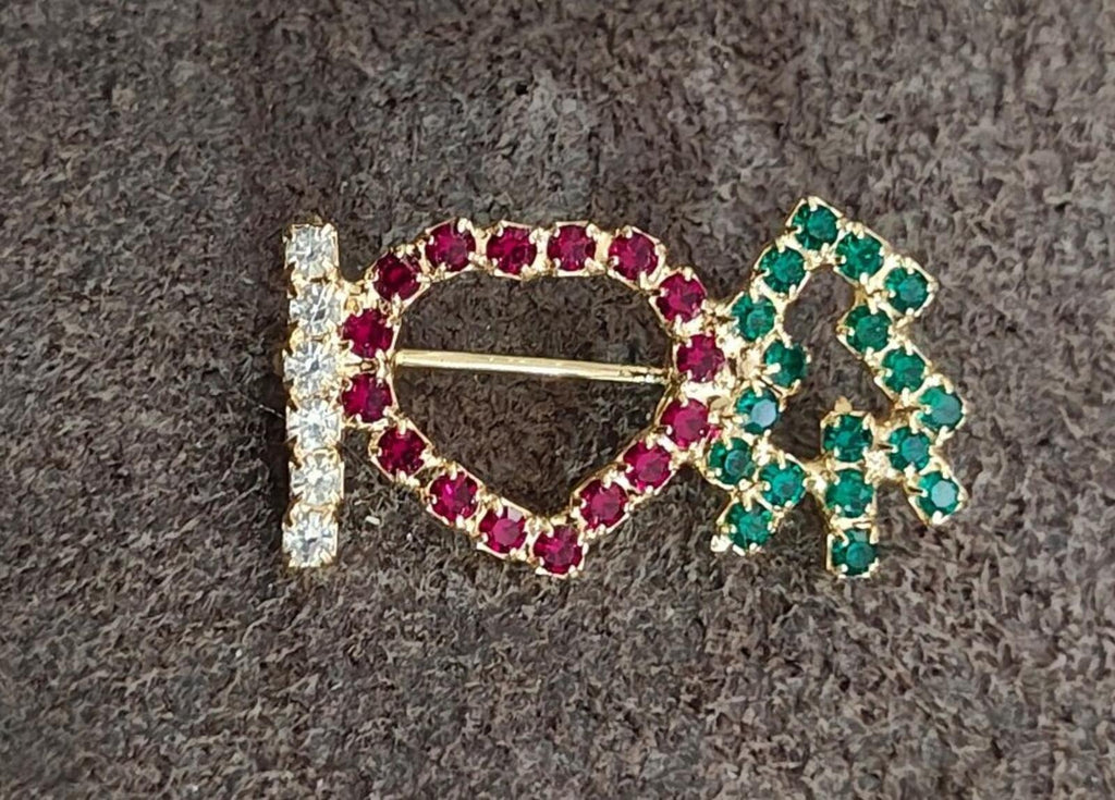 Red and green rhinestone brooch with heart outline, clear side stones, gold pin bar