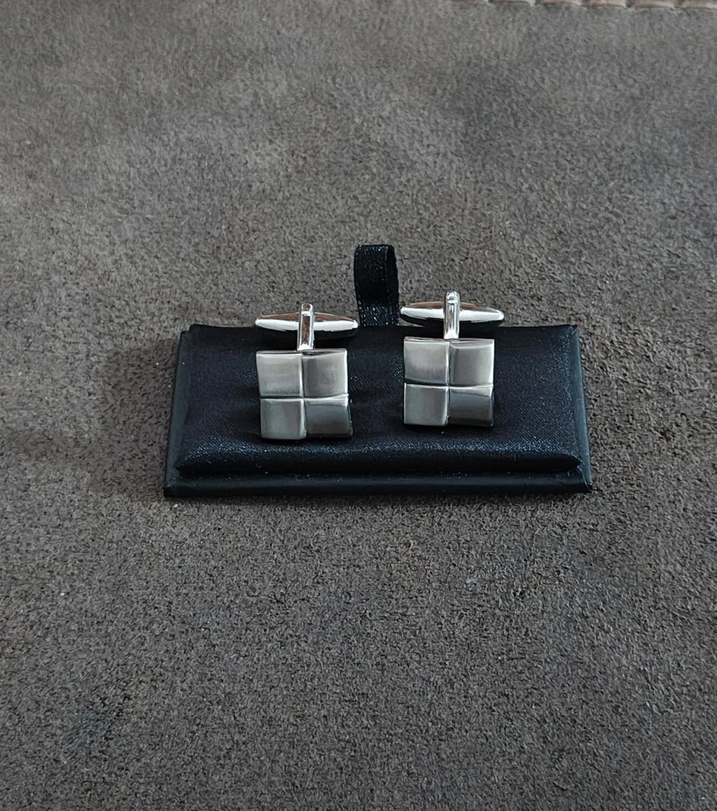 Brushed silver square cuff links shown centered on black display card