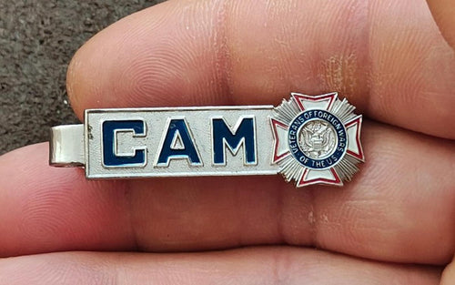 Silver-tone tie clip with blue “CAM” lettering and VFW-style star emblem