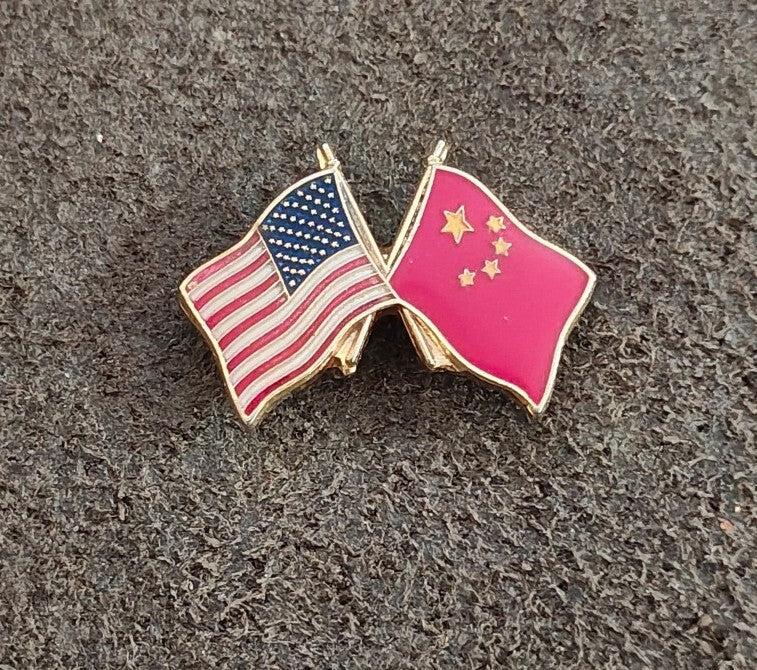Crossed US and China flag enamel lapel pin with gold outline and clasp posts.