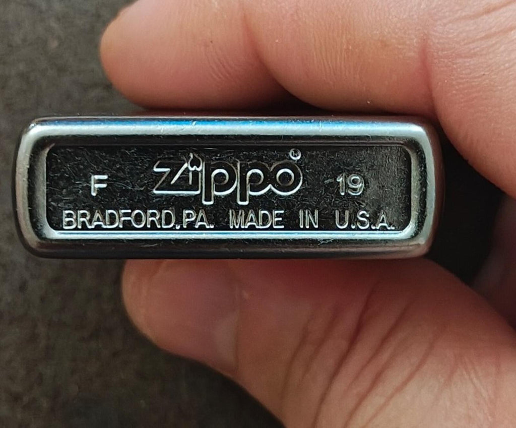Zippo windproof lighter bottom plate with stamped “Bradford, PA” markings.
