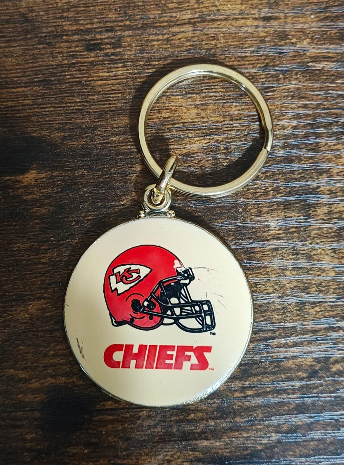 Round Kansas City Chiefs keychain medallion with gold ring and red helmet logo face