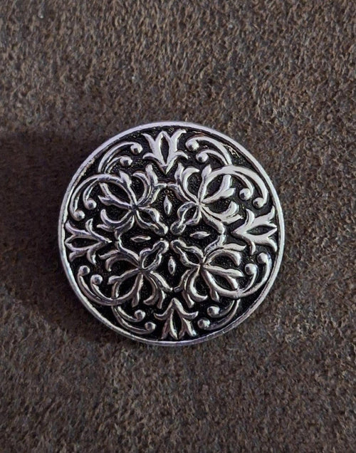 Silver round scarf clip featuring detailed floral scrolling filigree pattern