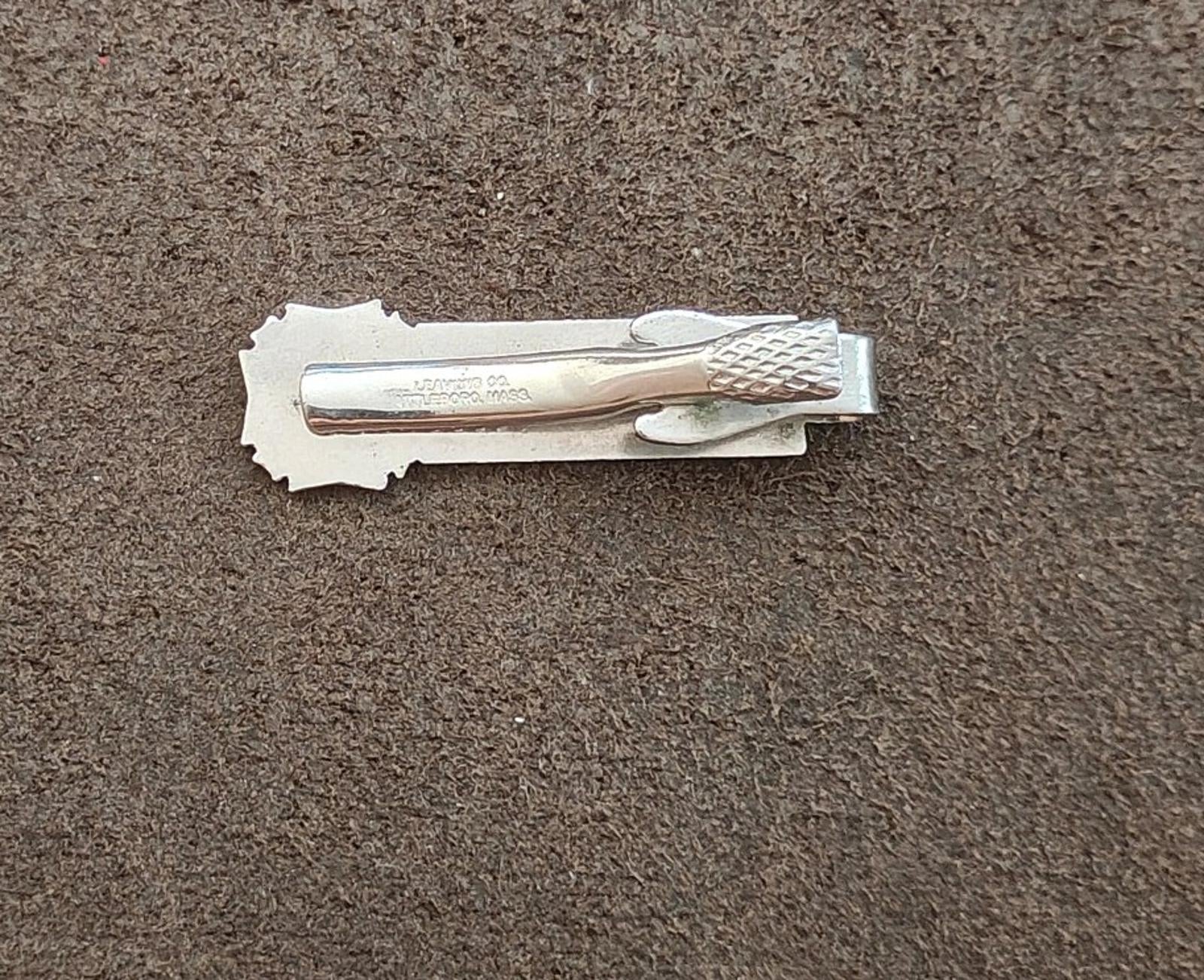 Silver-tone tie clip back view with clasp and stamped details