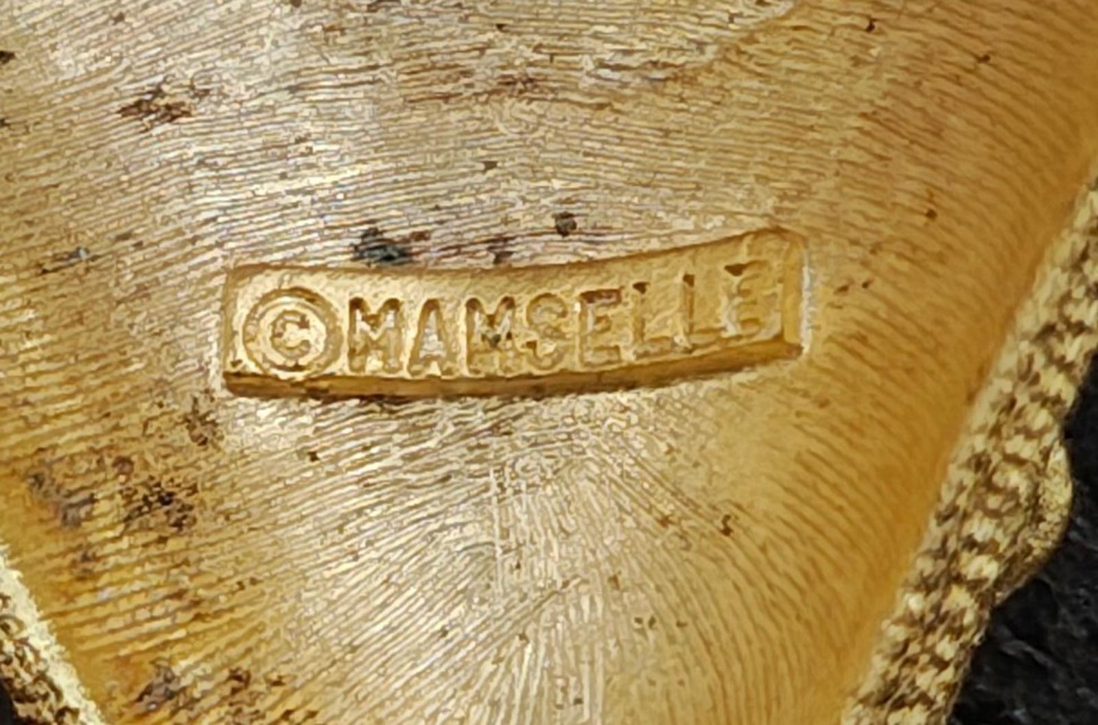 Gold tone Mamselle maker mark stamped on the back of the strawberry brooch pin.