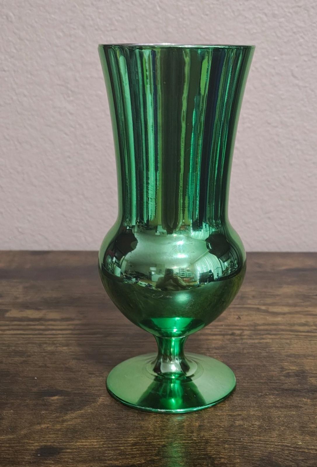 Green mirrored hurricane glass with rounded bowl base and flared top.