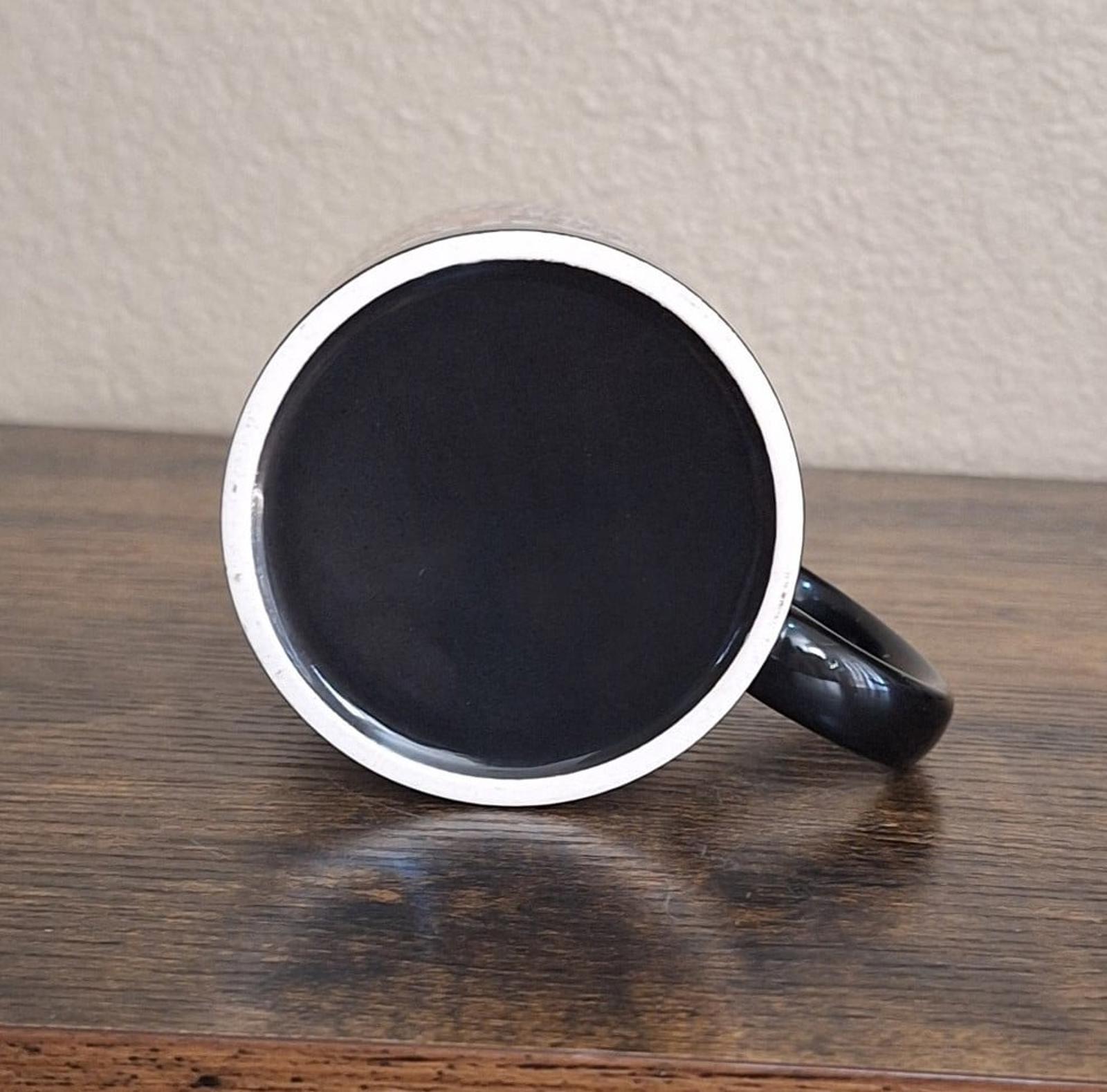 Black ceramic 11 oz mug underside view with silver rim and curved handle