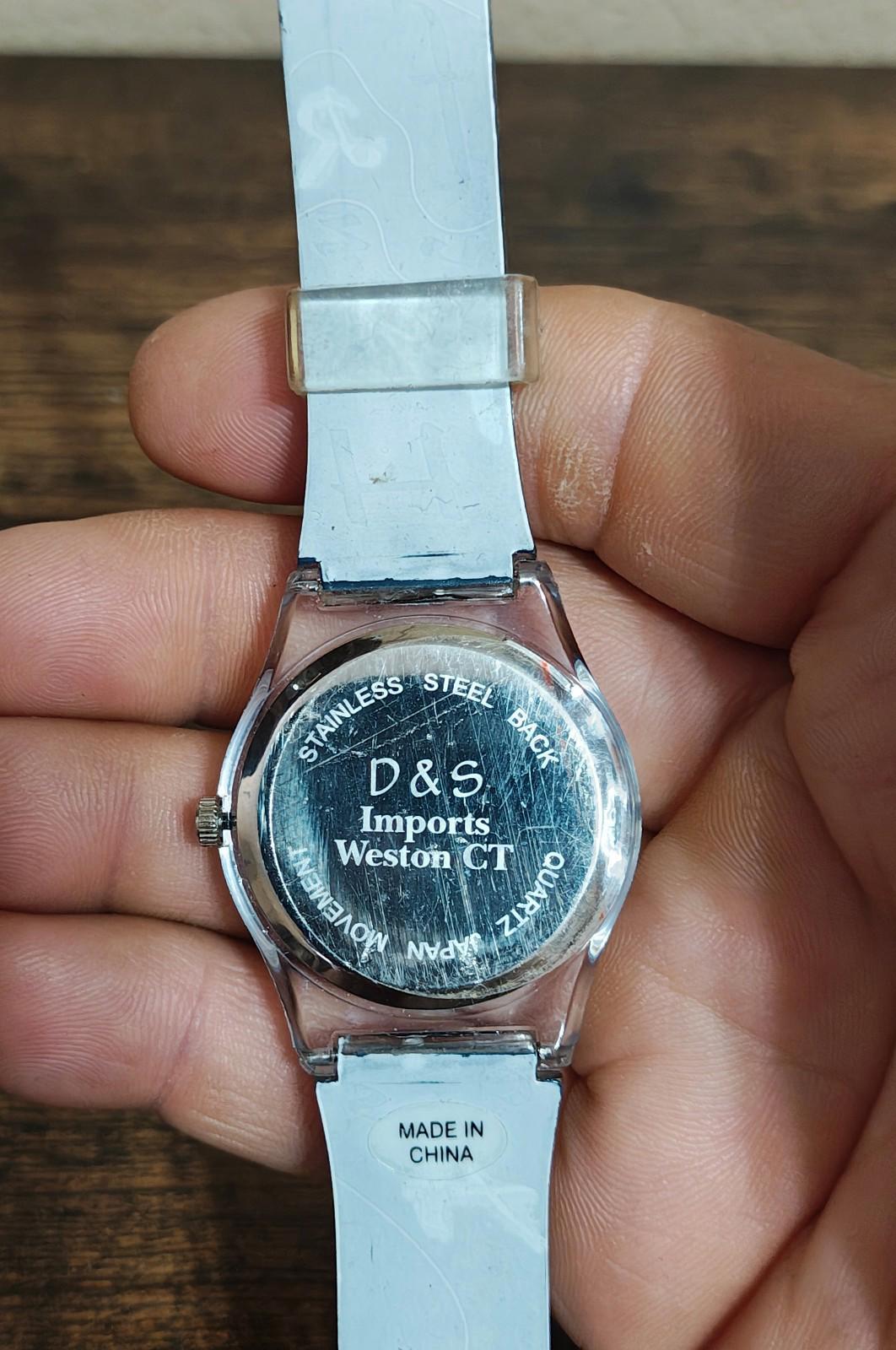 Unisex teacher watch back with silver case showing D&S and Made in China text