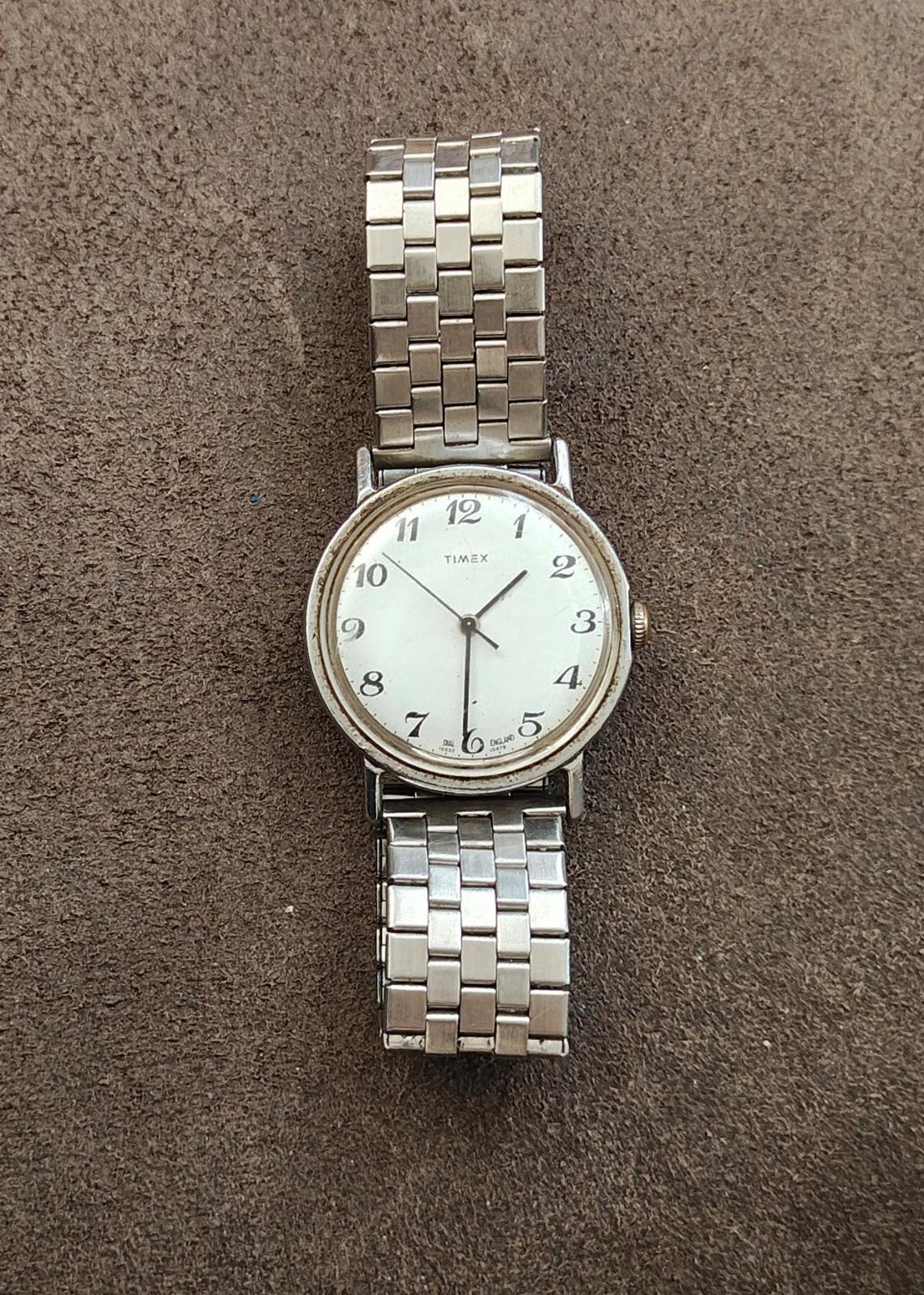 Timex Mercury men’s wristwatch on surface, silver dial and linked silver metal band