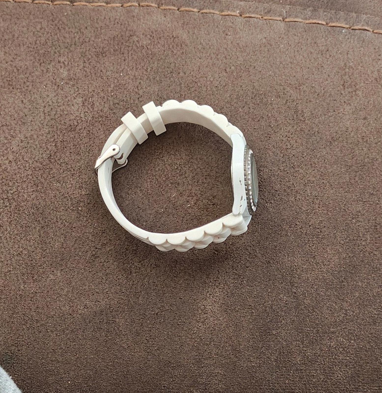 White silicone watch band with scalloped edge detail and silver-tone buckle clasp