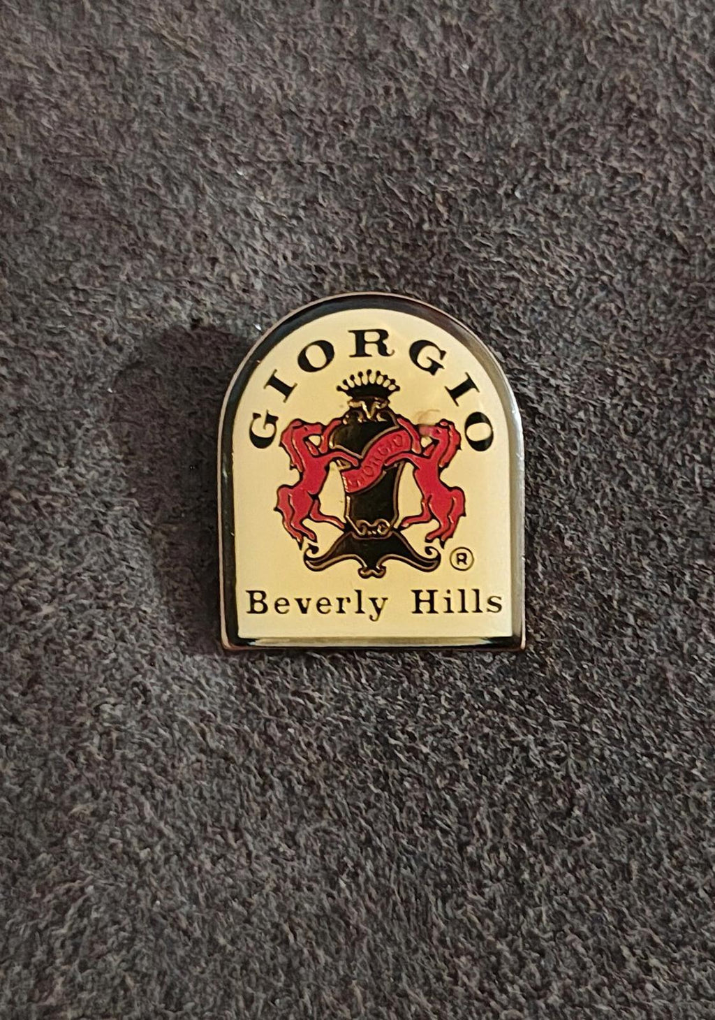 Gold-tone enamel badge pin showing the red and black lion crest and "Beverly Hills"