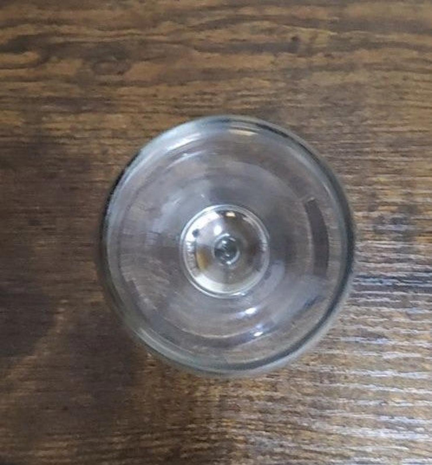 Bottom view of a clear stemmed wine glass with circular base