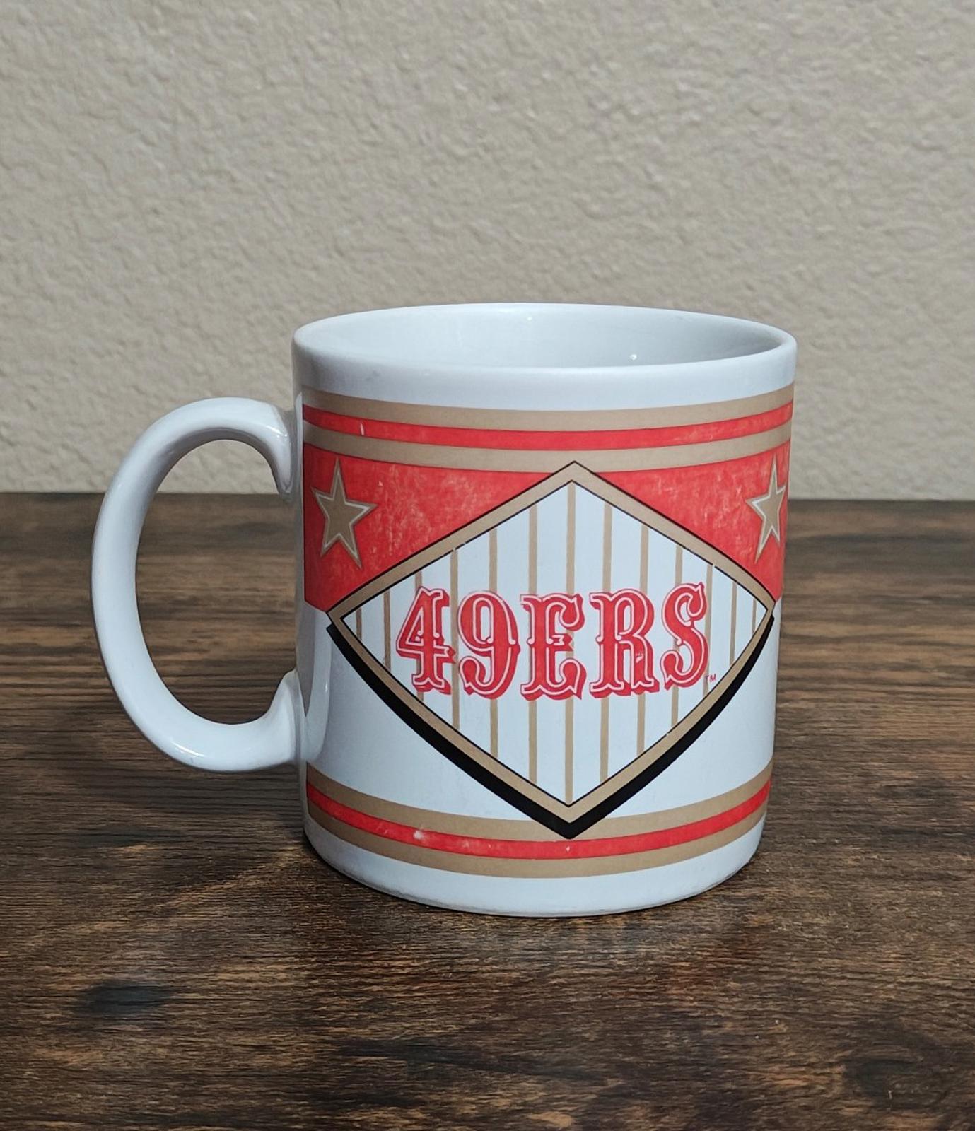 San Francisco 49ers “49ERS” diamond logo mug with red stars and stripes.