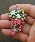 Colorful flower bouquet resin brooch with pink ribbon tails and green leaves