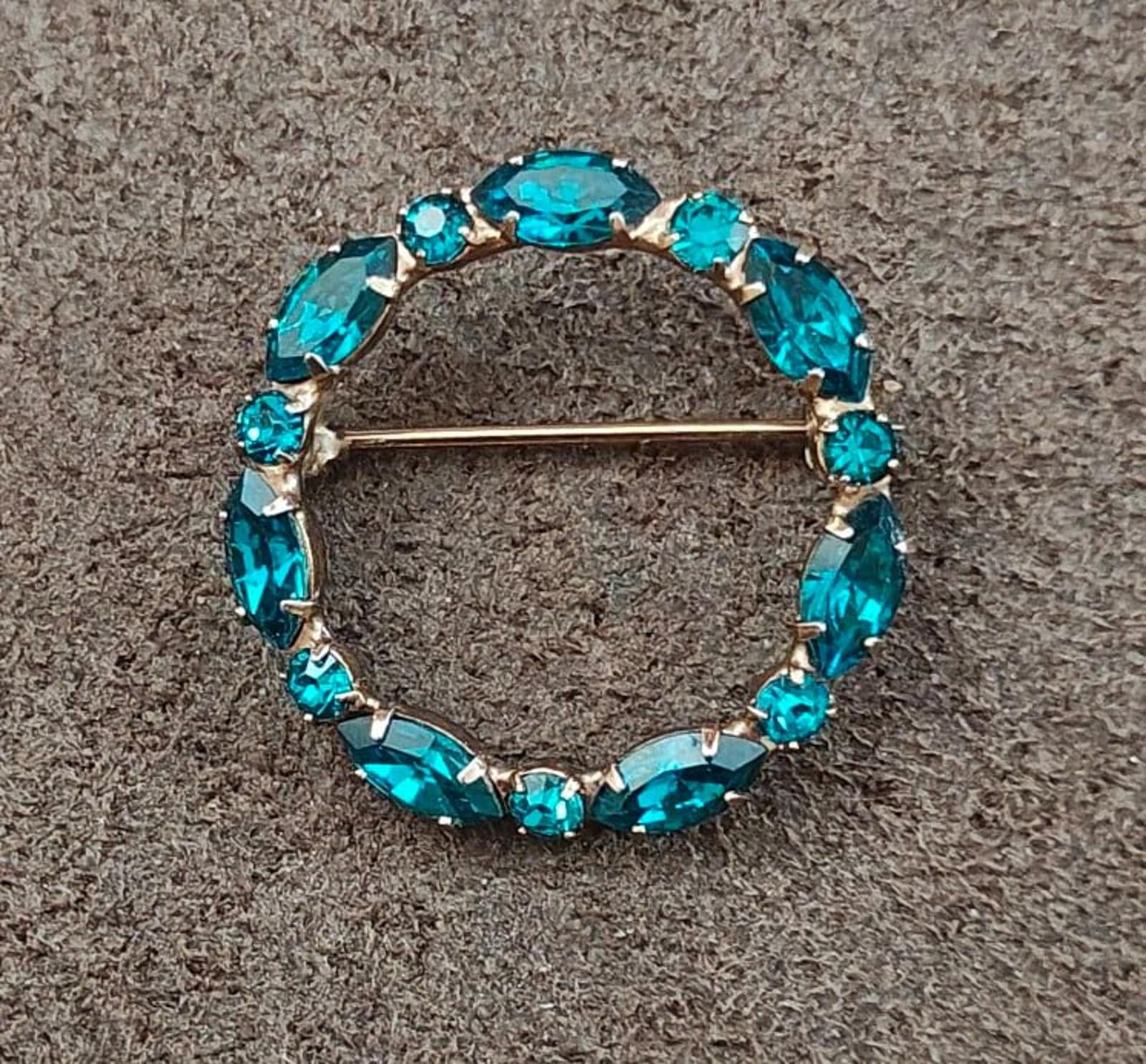 Aqua blue oval rhinestone halo brooch pin with gold-tone frame and bar closure