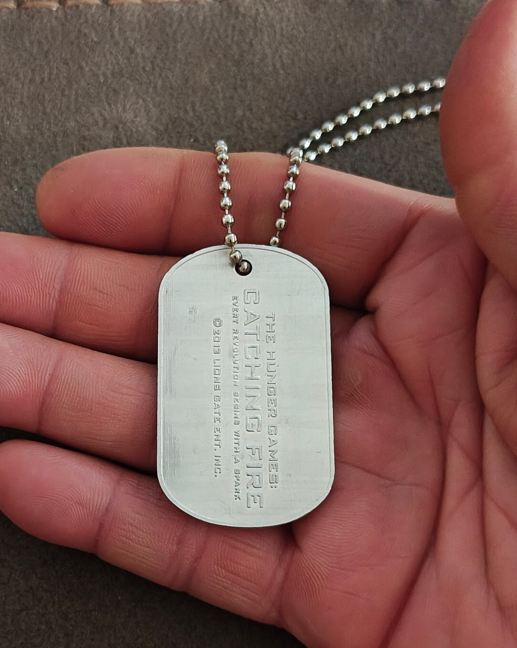 Promotional "The Hunger Games: Catching Fire" District 12 Victor Dog Tag