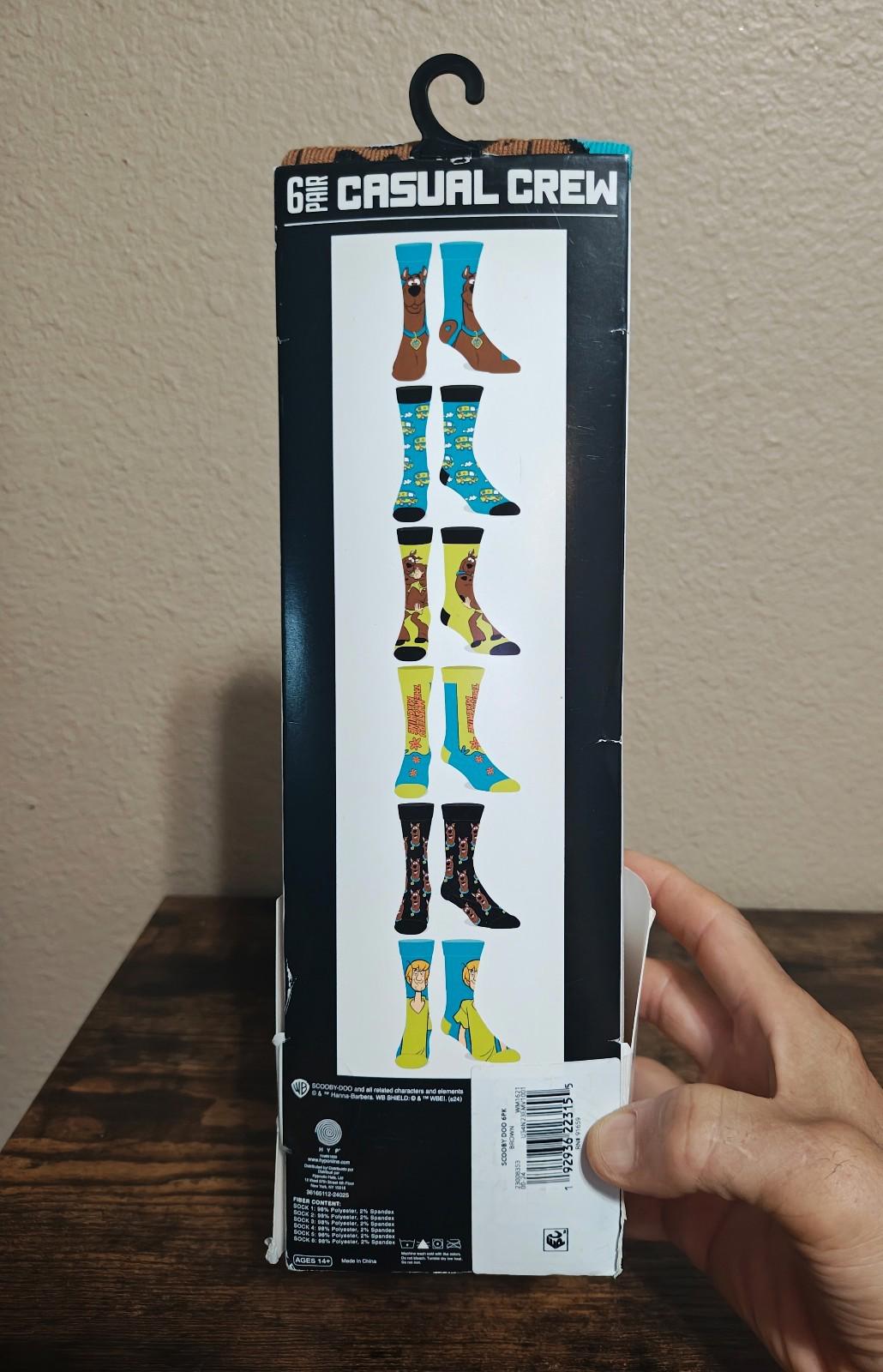Back view of men's casual crew socks 6-pack box with sock lineup and icons.