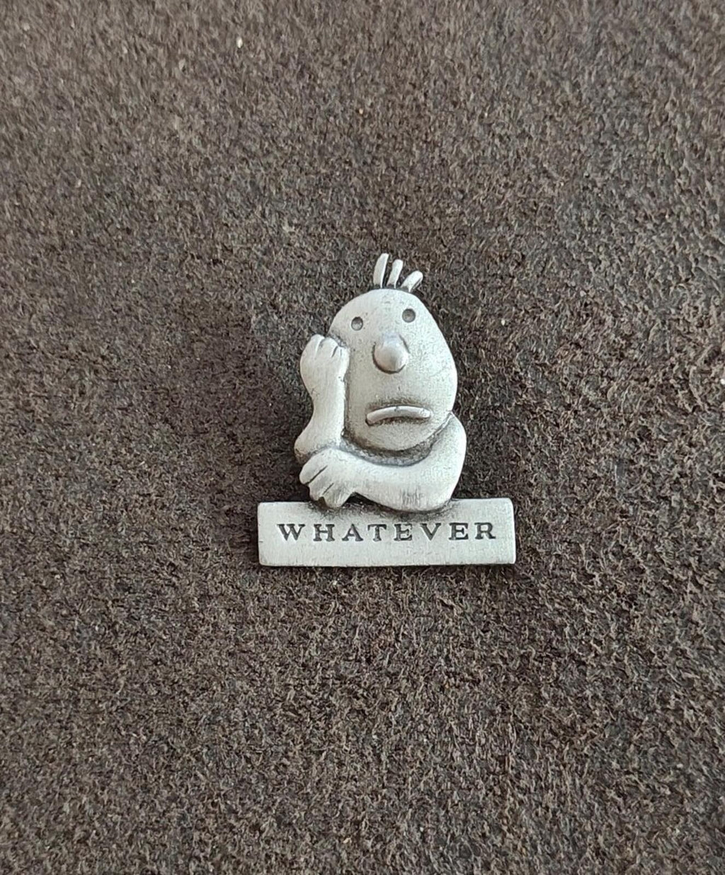 Vintage pewter cartoon pin of a smiling face with raised hair, "WHATEVER" base