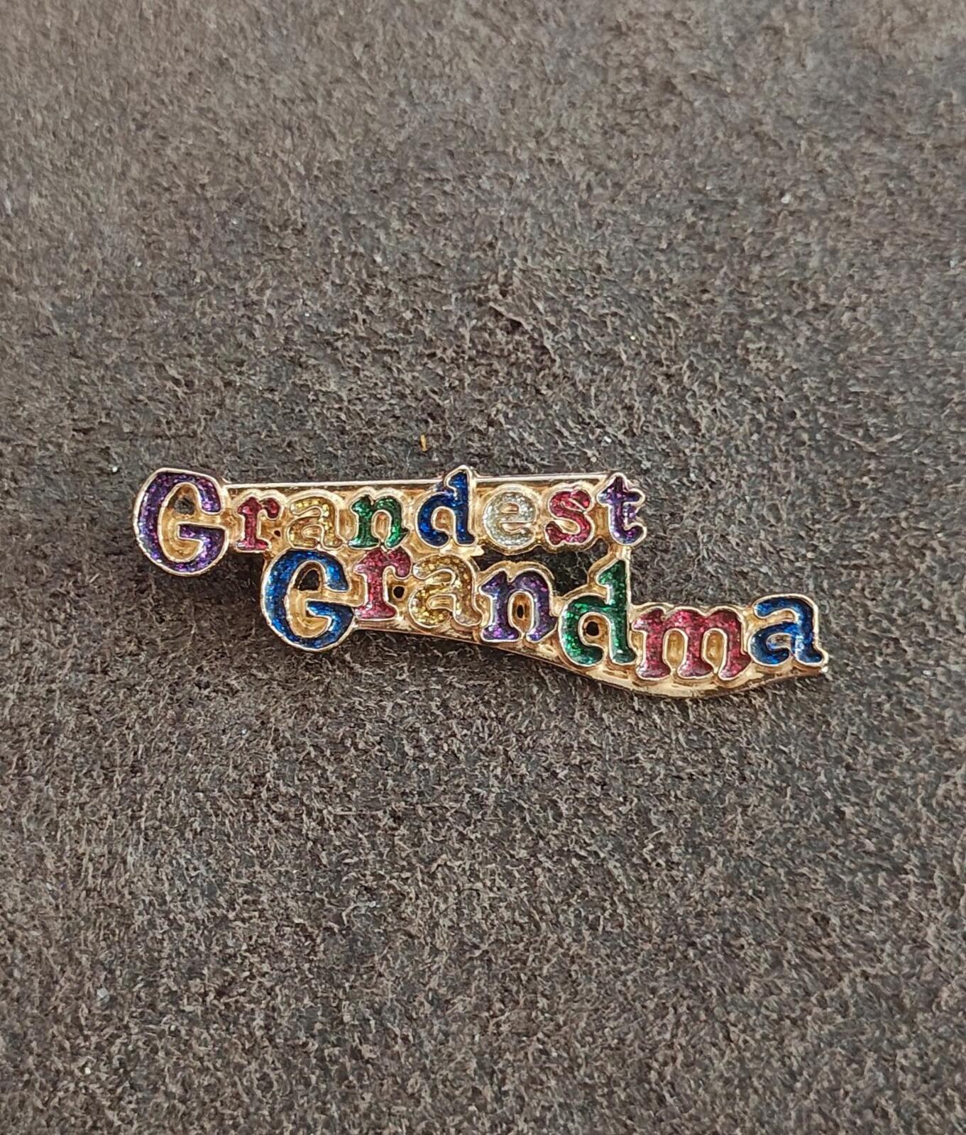 Grandma enamel brooch with gold-tone frame and colorful 'Grandest Grandma' lettering