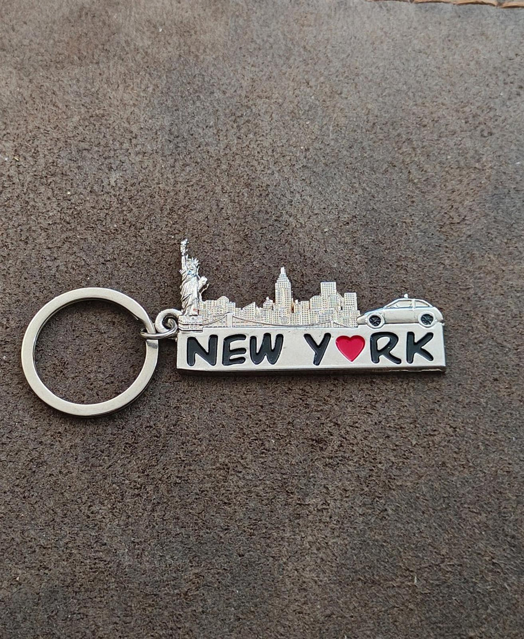 Silver New York keychain on pavement, engraved skyline, red heart "NEW YORK", key ring