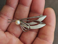 Sterling silver modernist brooch with cultured pearl and leaf-like metal cutouts