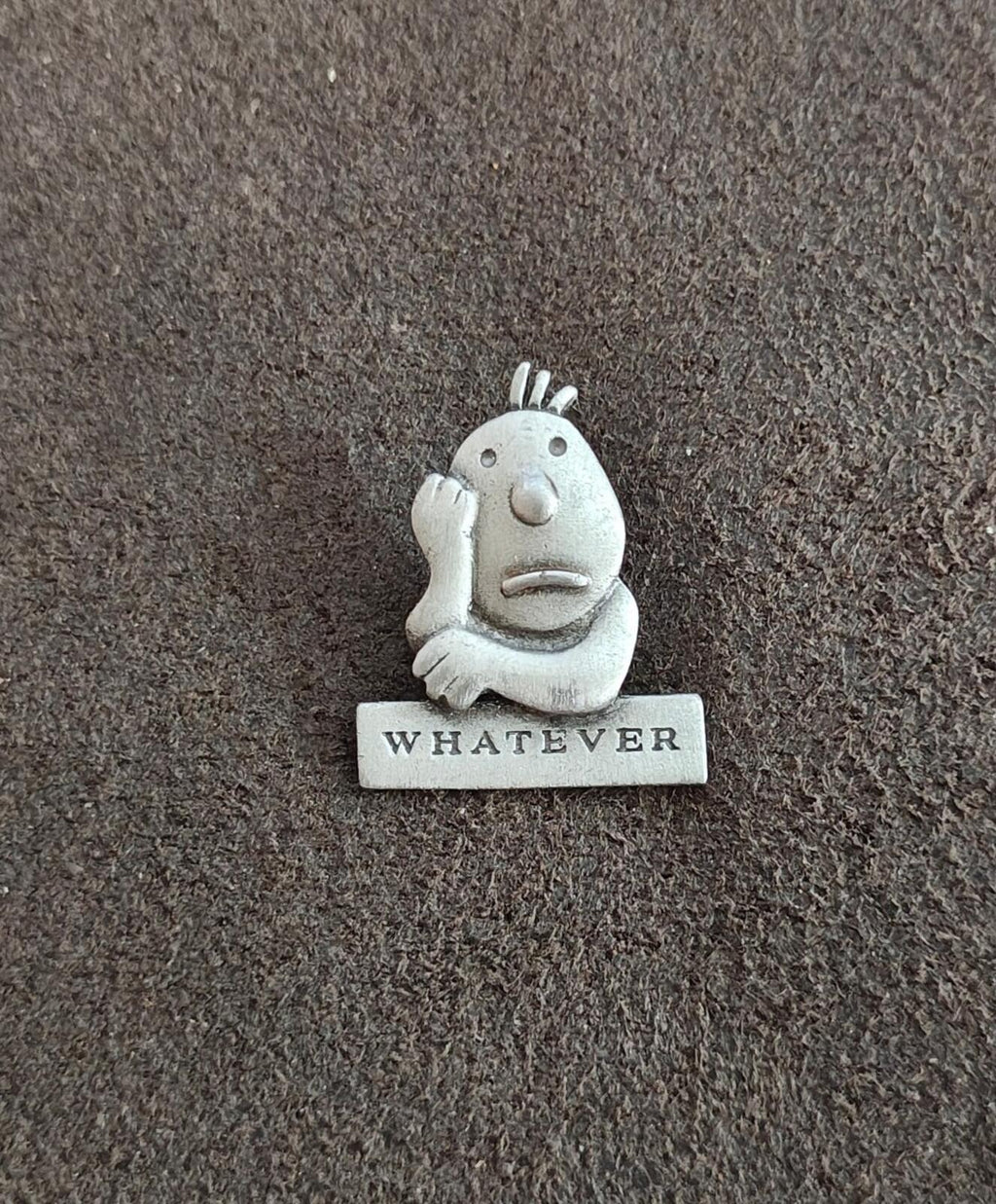 Vintage pewter cartoon pin of a smiling character with raised hair, "WHATEVER" base