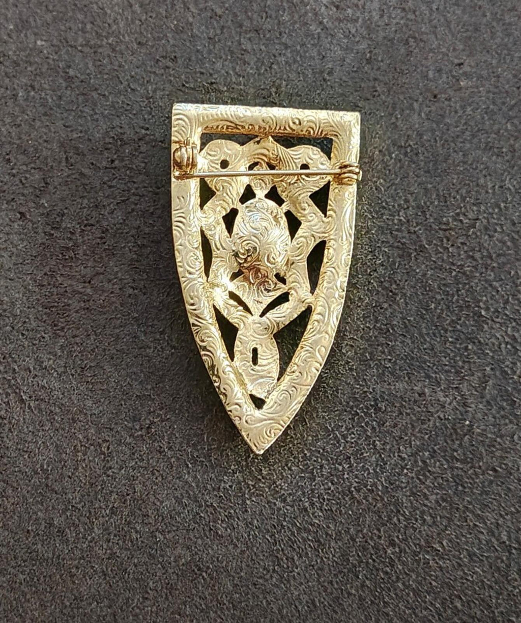Gold tone ornate back of shield brooch with engraved openwork design