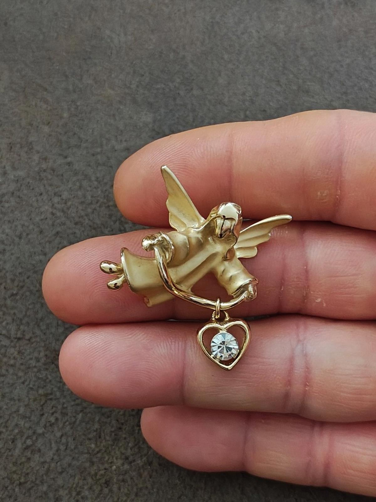 Gold-tone angel brooch pin with heart-shaped dangle charm and crystal center