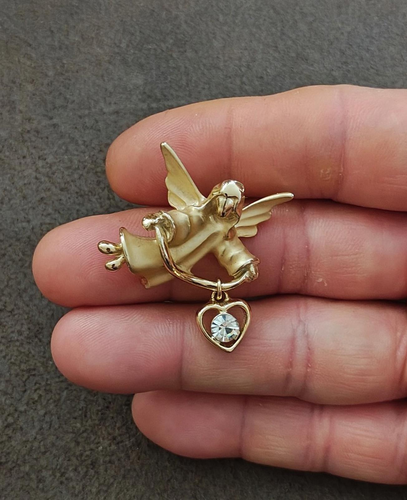 Gold-tone angel brooch pin on clasp with heart charm and crystal-like stone