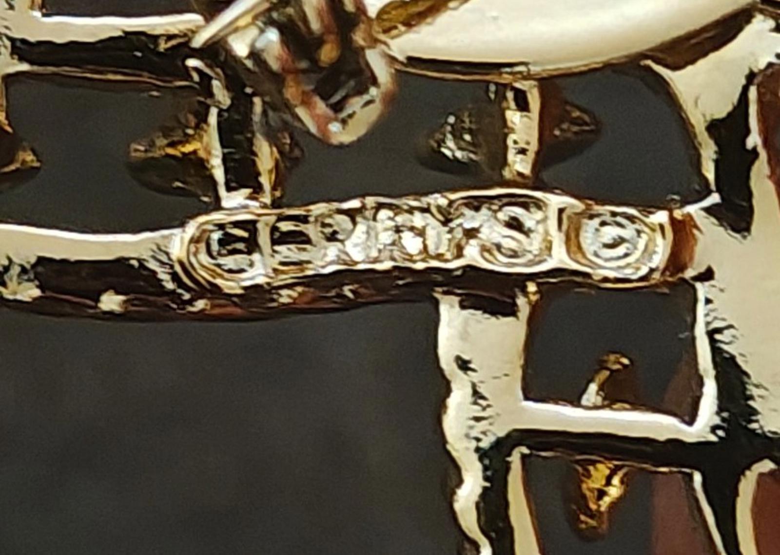 Gold-tone brooch pin mechanism with decorative bar clasp detail