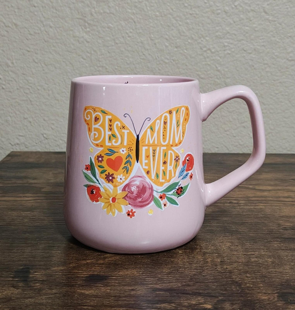 Pink ceramic mug with colorful floral and butterfly "Best Mom Ever" design