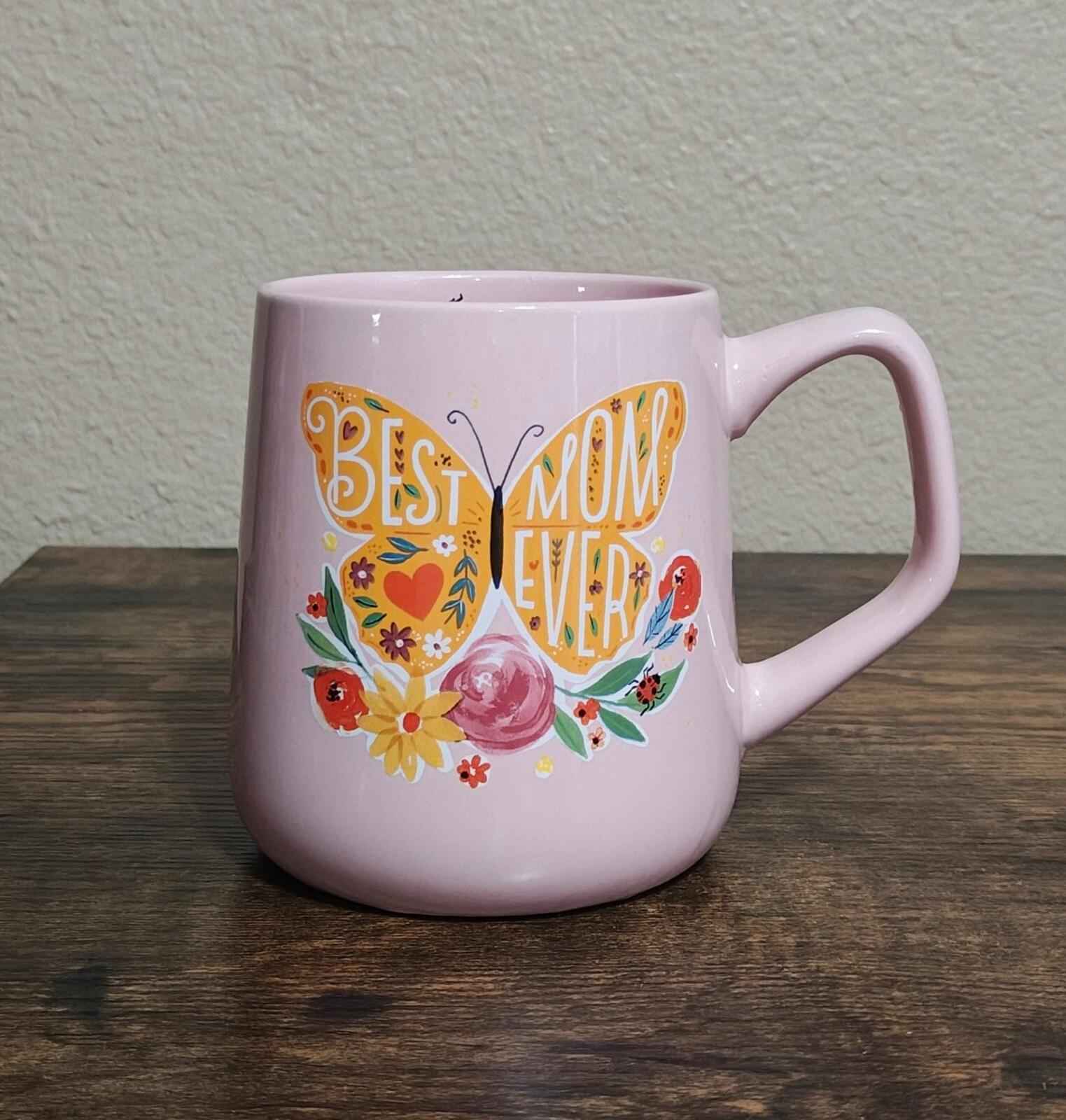 Pink ceramic mug with colorful floral and butterfly "Best Mom Ever" design