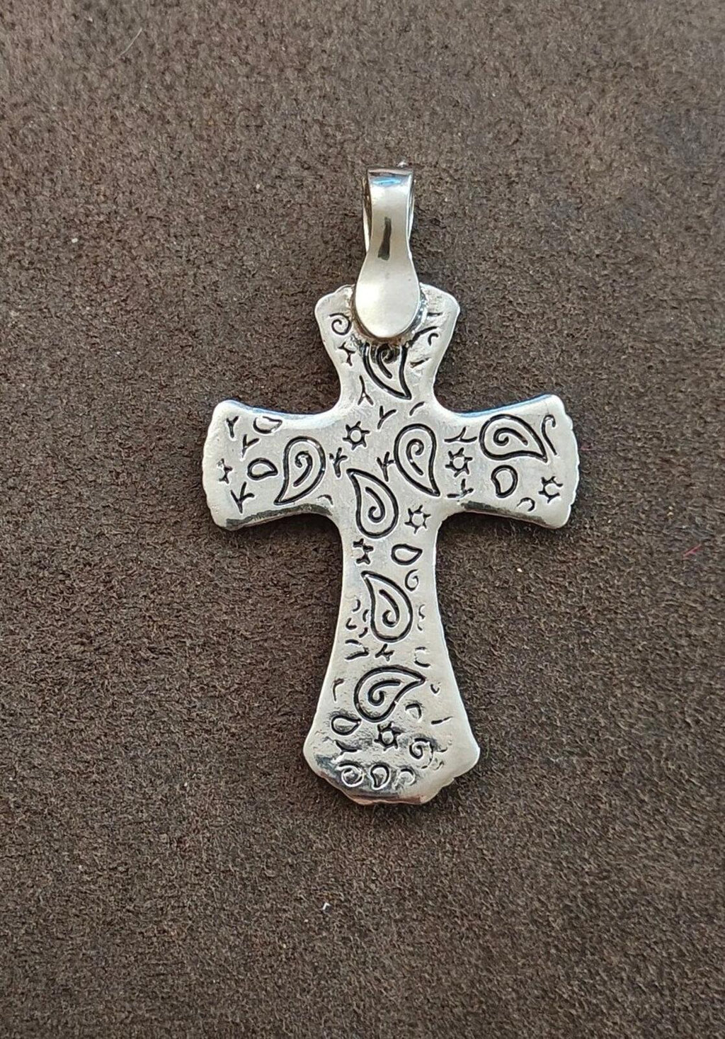 Silver-toned cross pendant back with engraved scrollwork and top loop bail