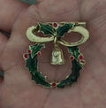 Christmas wreath enamel brooch with green leaves, red berries, gold bell and bow