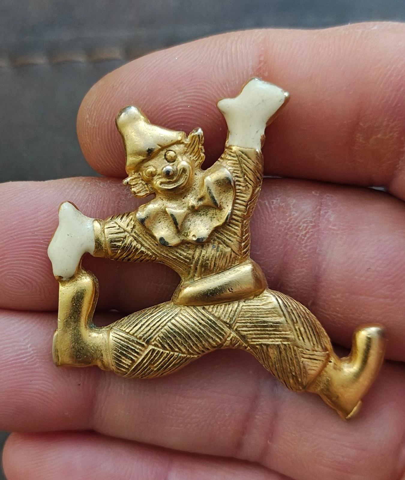 Gold tone clowning around pendant with white enamel hands and shoes, seated stretch pose