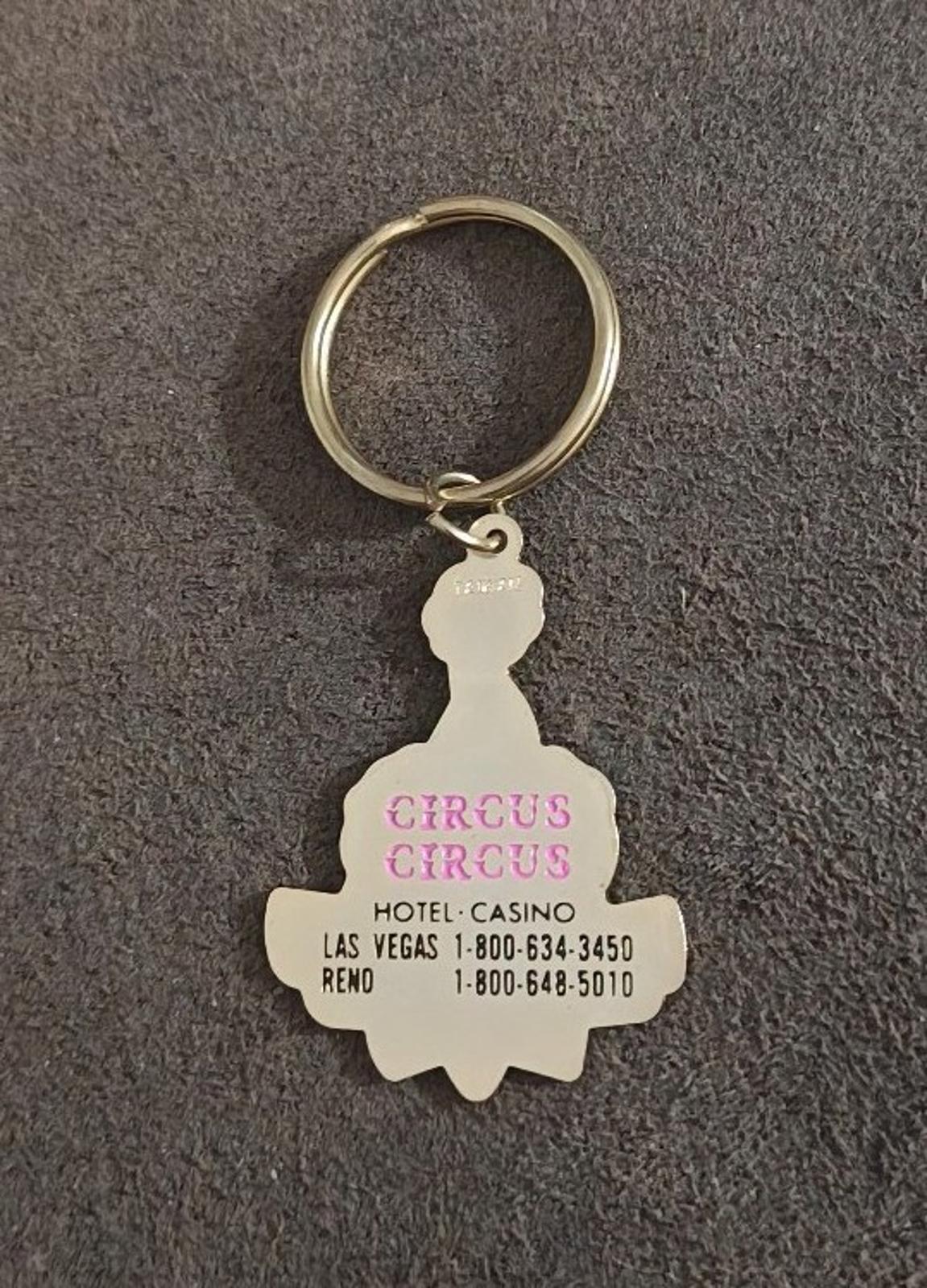 White clown keychain back charm with Circus Circus text, gold-tone ring