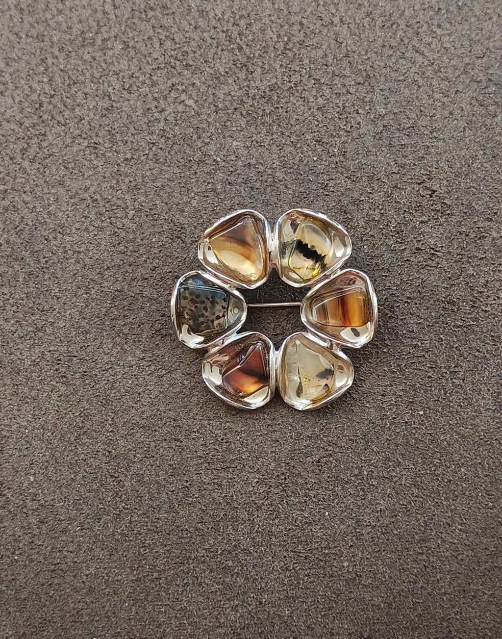 Circular gold-tone brooch with six faceted amber and smoky agate cabochons