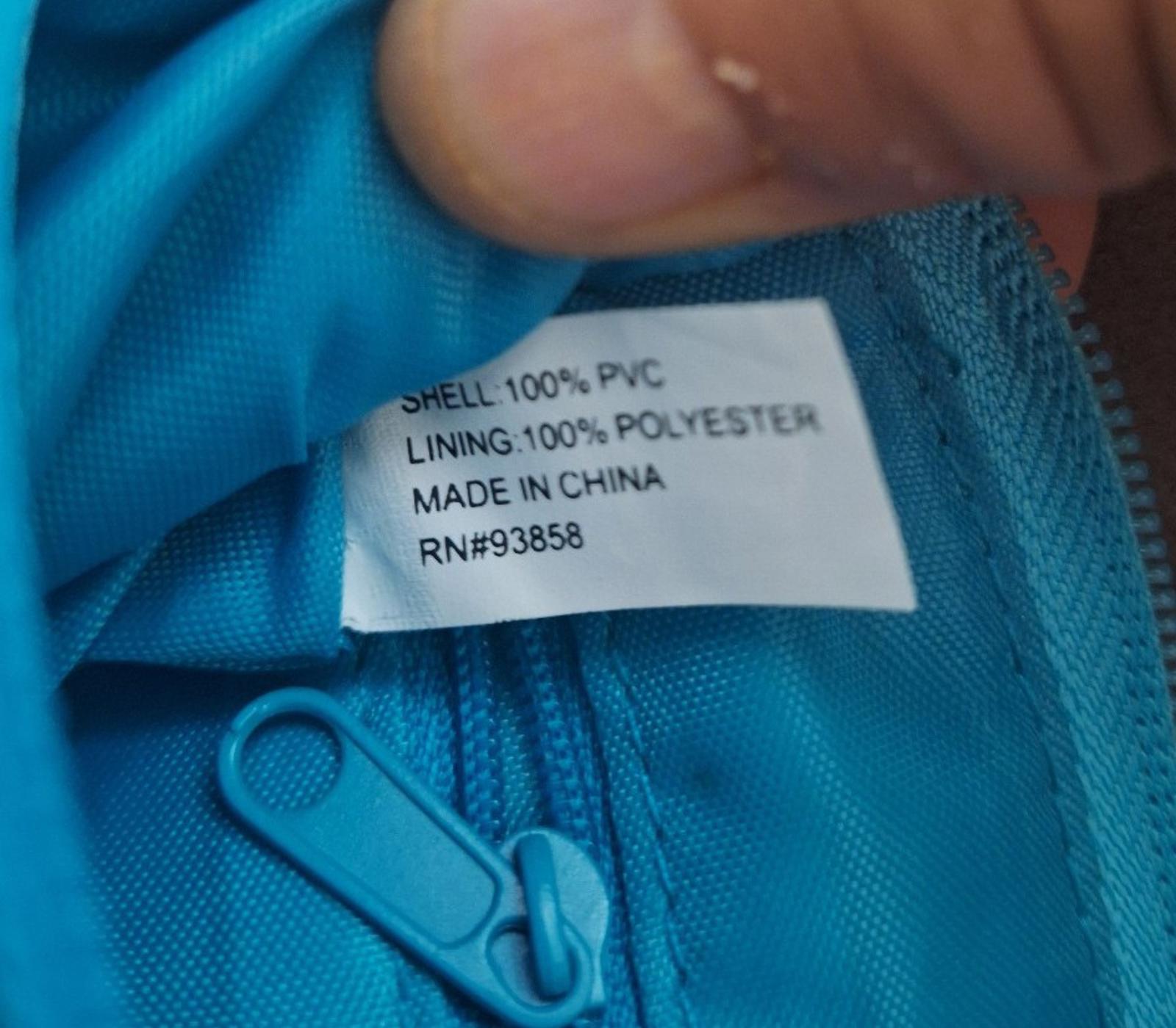 Blue fabric lining label inside clutch purse: 100% PVC shell, made in China