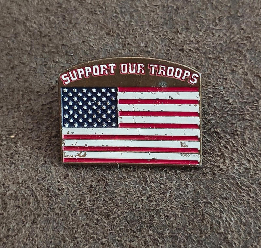 Gold-tone enamel pin with “Support Our Troops” wording and U.S. stars-and-stripes flag