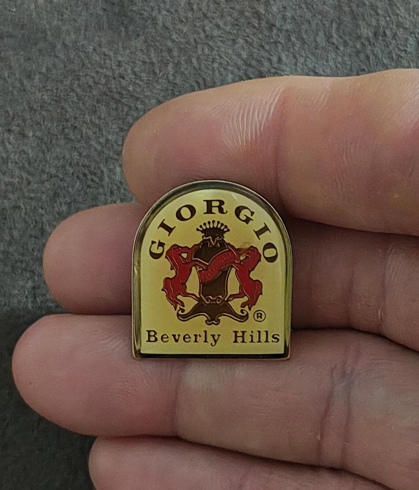 Gold-tone enamel crest pin with red lion, dark accents, and "Beverly Hills" text