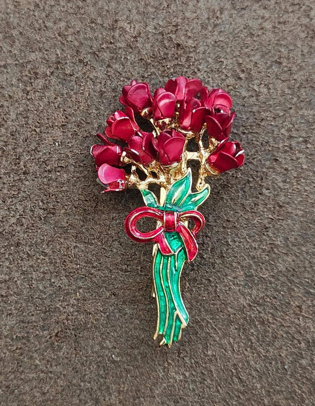 Red flower bouquet enamel brooch with gold-toned body, green stem, and red bow